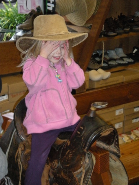 DSCN0065.jpg-Cowgirl! : While SaraGrace tried on shoees; the kids tried on the saddle