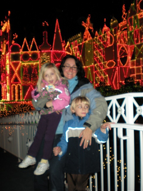 DSCN0103.jpg-Mom and the kids in front of "It's A Small World" : It's A Small World was lit up fantastically for the season