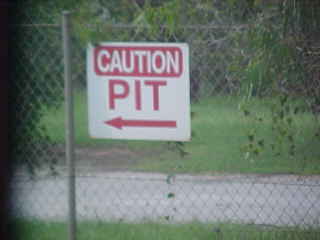 Sign reads: Caution Pit