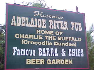 Sign reads: Historic Adelaide River Pub Home of Charlie the buffalo (Crocodile Dundee) Famous Barra & Chips Beer Garden