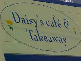 Sign says: Daisy's Cafe & Take Away