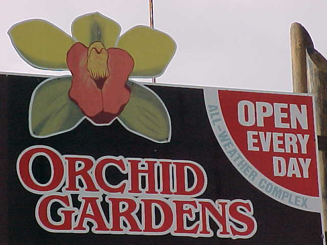 Sign says: Orchid Gardens.   Open Every Day.    All-Weather Complex (New Zealand, North Island, The Travel Addicts)