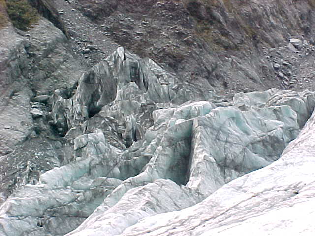 What appears as earth - sometimes complete with vegetation, is actually dirt on top of the snow (The Travel Addicts, New Zealand, South Island)