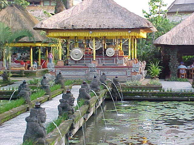 looking over the pond past the fountains to the gongs at the Palace restaurant in Ubud, Bali