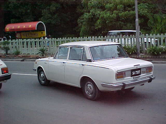 Look familure Dad? But shouldn't the number plate read "366 BAU"? : My father used to have one of these.  It's a 1970 "Toyota Corrolla Deluxe".  It is the first car I ever drove on a regular basis.  It has a snappy 1900cc engine and 4 on the floor. (Malaysia, The Travel Addicts)