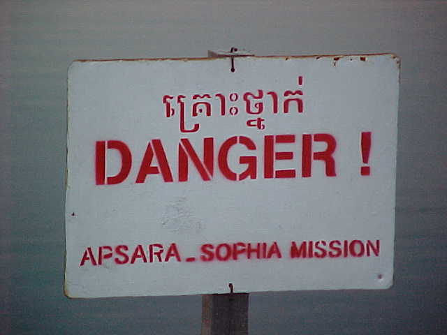 Land mines are still present in much of Cambodia : Sign says: \ (something in Khmer) \ Danger! \ Apsara_Sophia Mission (Cambodia, The Travel Addicts)