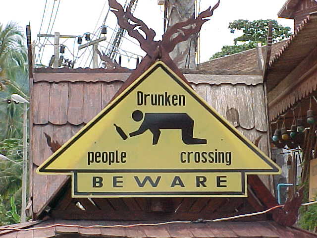 Sign in Lamai : Sign says: Drunken people crossing.  \ Beware (Thailand, The Travel Addicts)