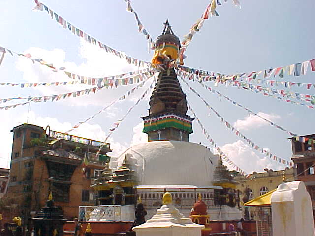 Mini Swayambhunath stupa with prayer flags : Mini Swayambhunath is a copy of the Swayambhunath Pagoda that requires many steps to get there. This one was built in the 1600's to allow those that could not climb the steps to attend the pagoda. (Nepal, The Travel Addicts)