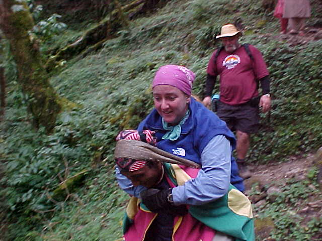 SGK hurts her ankle and has to be carried down the mountain by Kirin (and later by Captain) (Nepal, The Travel Addicts)