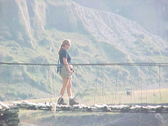 SGK intrepidly crossing the bridge (Nepal, The Travel Addicts)