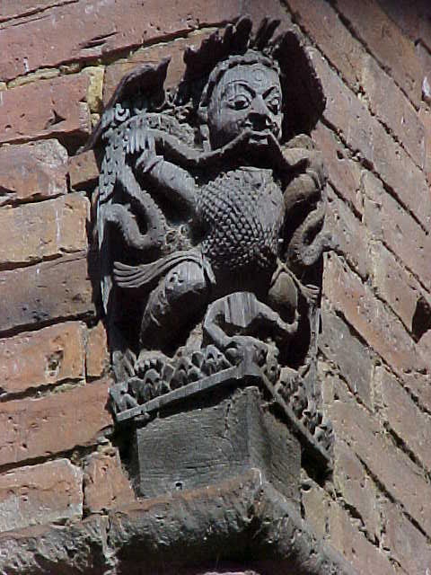 Cornice sculpture : Not a gargoyle.  Gargoyle's specifically function as drainspouts. (Nepal, The Travel Addicts)