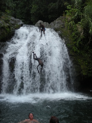 SGK in the foreground and kids jumping off the waterfall.